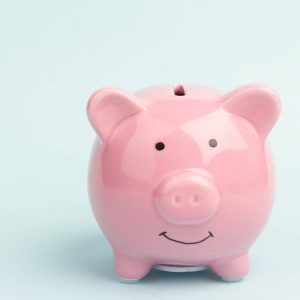 Piggy bank on blue background, space for text. Finance, saving money Piggy bank on blue background